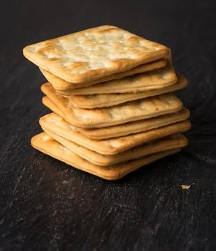 Stack of biscuits on a black table top, closeup Stock Photos