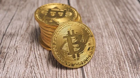 Stack of Bitcoin Coins on a Table Camera Turning Around Stock Footage 88407580