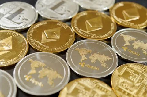 Stack of bitcoin, ripple, etherum and litecoin coins. Virtual currency concept. Stock Photos