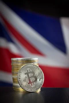 Stack of bitcoins and flag of the United Kingdom Stock Photos