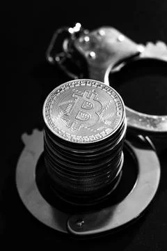 Stack of bitcoins and handcuffs Stock Photos
