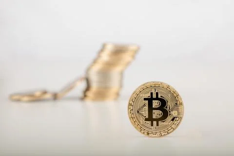 Stack of bitcoins with bitcoins background on gray surface Stock Photos