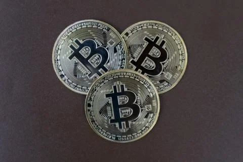Stack of Bitcoins on a brown background Stock Photos