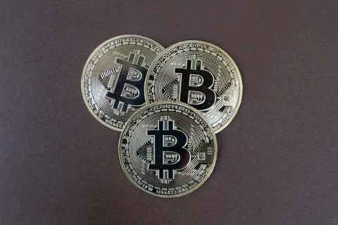 Stack of Bitcoins on a brown background Stock Photos