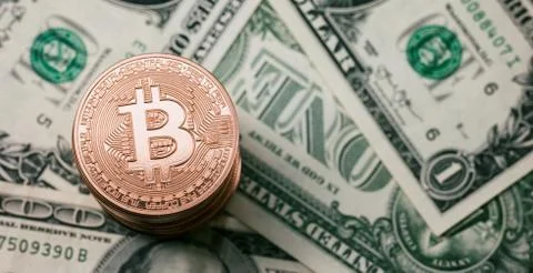 Stack of Bitcoins coins on dollar notes Stock Photos