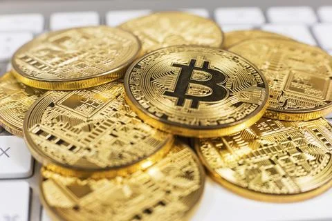 Stack of bitcoins lying on computer keyboard Foto stock