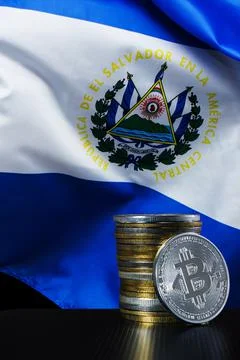 Stack of bitcoins over El Salvador blurred flag. Stock Photos