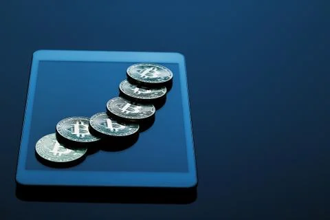 Stack of bitcoins on tablet computer Stock Photos