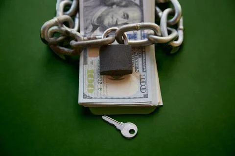 Stack of black-and-white hundred-dollar bills and a chain with a lock on the  Stock Photos