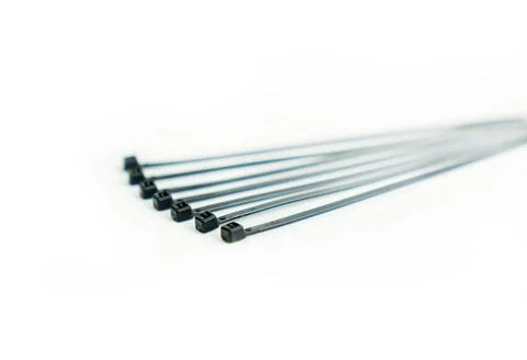 Stack of black cable ties on white background. Stock-Fotos