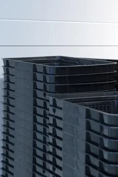 A stack of black empty baskets. Containers for food Stock Photos