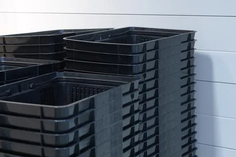 A stack of black empty baskets. Containers for food Stock Photos