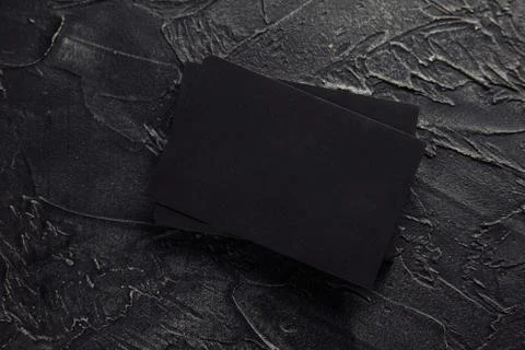 Stack of black envelopes on a dark table Stock Photos