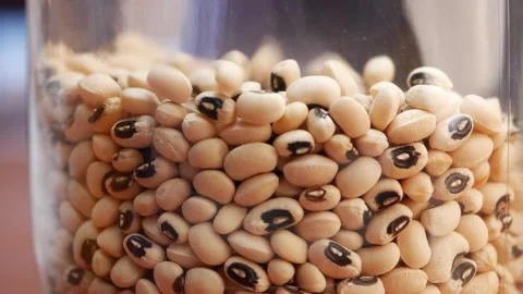 A stack of black eyed peas and a pile of black eyed peas, along with a pile of Stock Footage 248424686