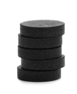 Stack of black pills on white background. Medical treatment Stock Photos