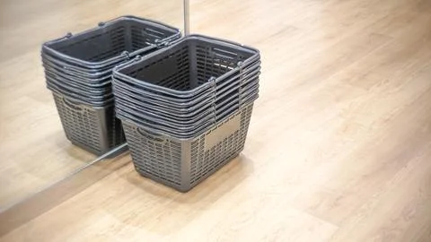 A stack of black plastic shopping baskets. Stock Photos