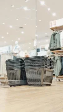A stack of black plastic shopping baskets. Stock Photos
