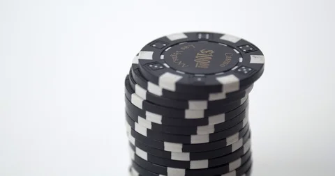 Stack of black poker chips lifted Stock Footage 112329526