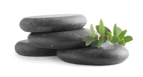 Stack of black spa stones with eucalyptus isolated on white 스톡 사진