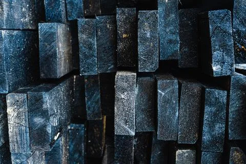 A stack of black specially burnt boards for better preservation of the materi Stock Photos