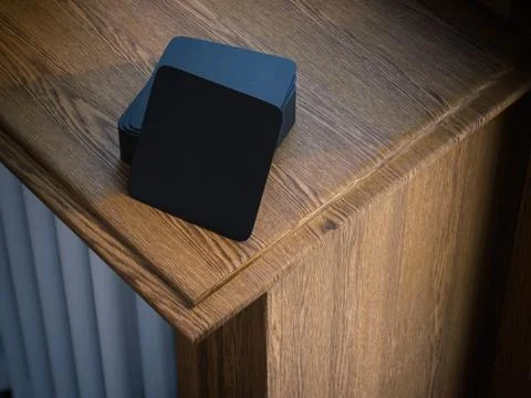 Stack of black square beer coasters on windowsill. 3d rendering Stock Illustration