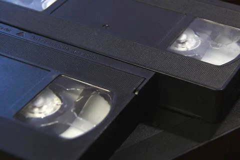 Stack of black VHS tape video cassettes close up Stock Photos