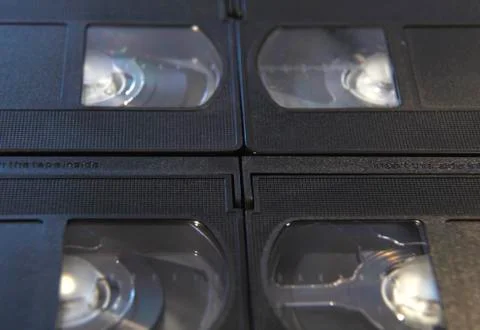 Stack of black VHS tape video cassettes close up Stock Photos