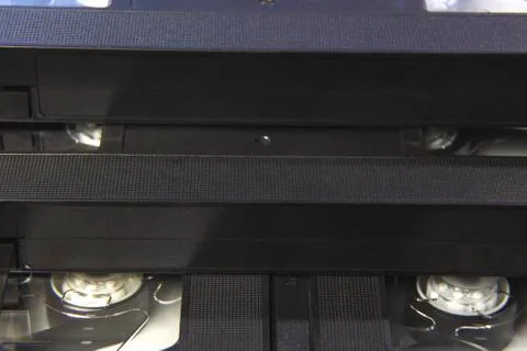 Stack of black VHS tape video cassettes close up Stock Photos