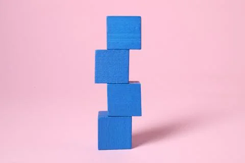 Stack of blank blue cubes on pink background 스톡 사진