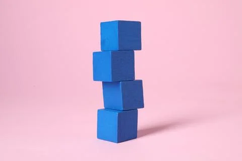 Stack of blank blue cubes on pink background 스톡 사진