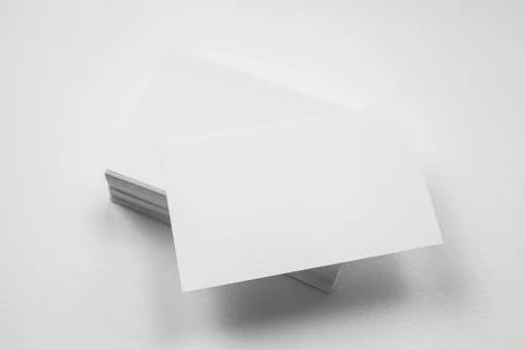 Stack of blank business card with one card in front on white background Stock Photos