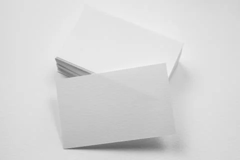 Stack of blank business card with one card in front on white background Stock Photos
