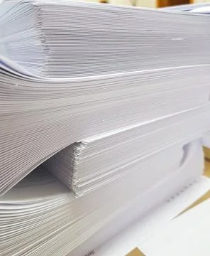 A stack of blank paper, book blocks prepared for binding in a printing house Stock Photos