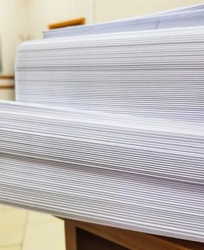 A stack of blank paper, book blocks prepared for binding in a printing house 库存照片