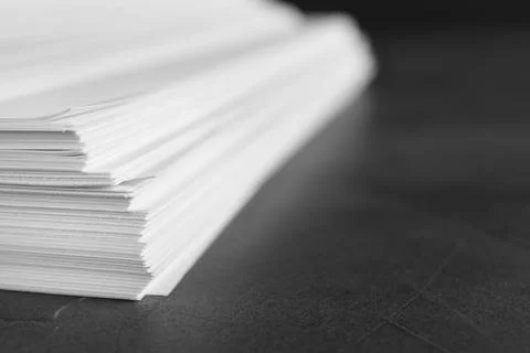 Stack of blank paper on grey stone table, closeup. Space for text Stock Photos