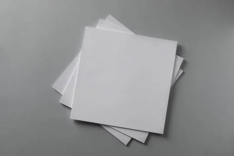 Stack of blank paper sheets for brochure on light grey background, top view Foto stock