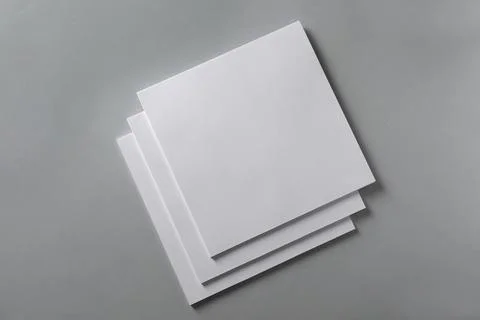 Stack of blank paper sheets for brochure on light grey background, top view Stock Photos