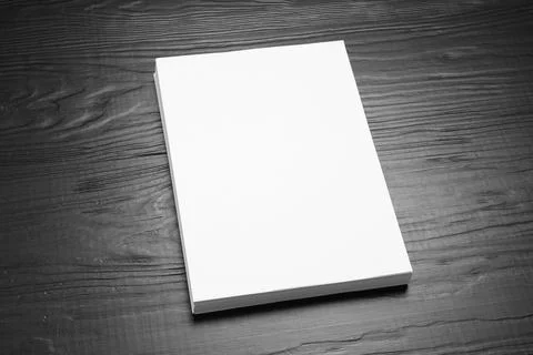 Stack of blank paper sheets for brochure on black wooden background. Mock up 스톡 사진