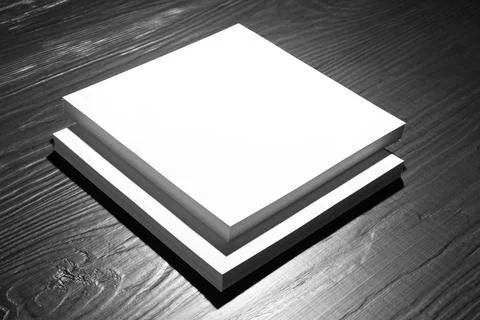 Stack of blank paper sheets for brochure on black wooden background. Mock up 스톡 사진