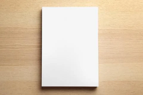 Stack of blank paper sheets for brochure on wooden background, top view. Mock Stock Photos