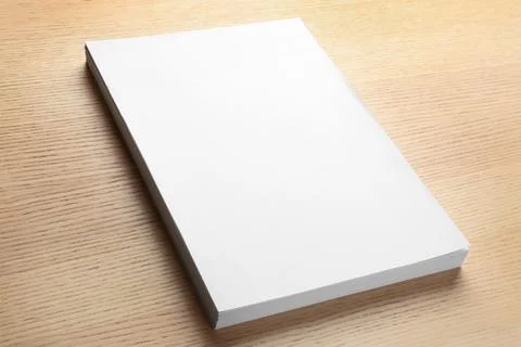 Stack of blank paper sheets for brochure on wooden background. Mock up Foto stock