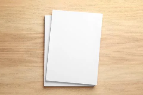Stack of blank paper sheets for brochure on wooden background, top view. Mock 스톡 사진