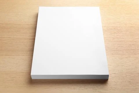Stack of blank paper sheets for brochure on wooden background. Mock up Stock Photos