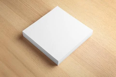 Stack of blank paper sheets for brochure on wooden background. Mock up Stock Photos