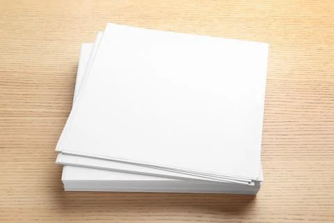 Stack of blank paper sheets for brochure on wooden background. Mock up 写真素材