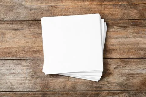 Stack of blank paper sheets for brochure on wooden background, top view. Mock 스톡 사진