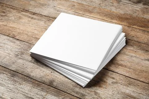 Stack of blank paper sheets for brochure on wooden background. Mock up Stock Photos