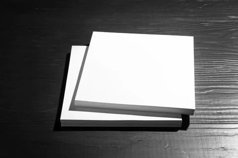 Stack of blank paper sheets for brochure on black wooden background. Mock up 스톡 사진