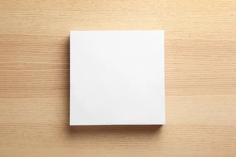Stack of blank paper sheets for brochure on wooden background, top view. Mock Stock Photos