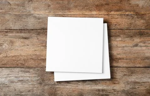 Stack of blank paper sheets for brochure on wooden background, top view. Mock Foto stock